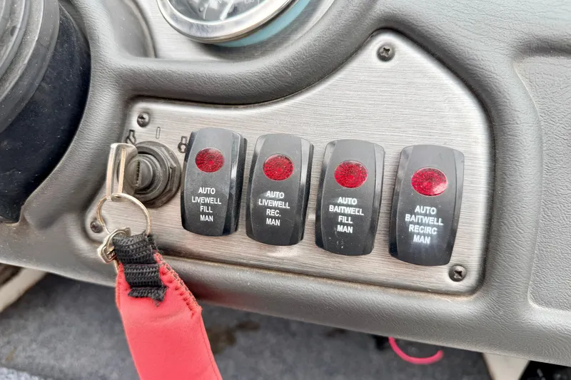 Slide: The Image of Control panel of a 2012 Skeeter SL 185 boat with switches for livewell and baitwell functions. - 40