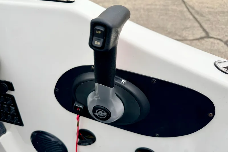 Slide: The Image of Throttle control lever on a 2012 Skeeter SL 185 boat dashboard. - 41