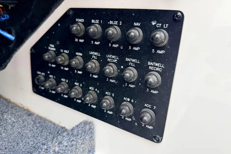 Slide: The Image of Control panel of a 2012 Skeeter SL 185 boat with labeled switches and amps. - 42