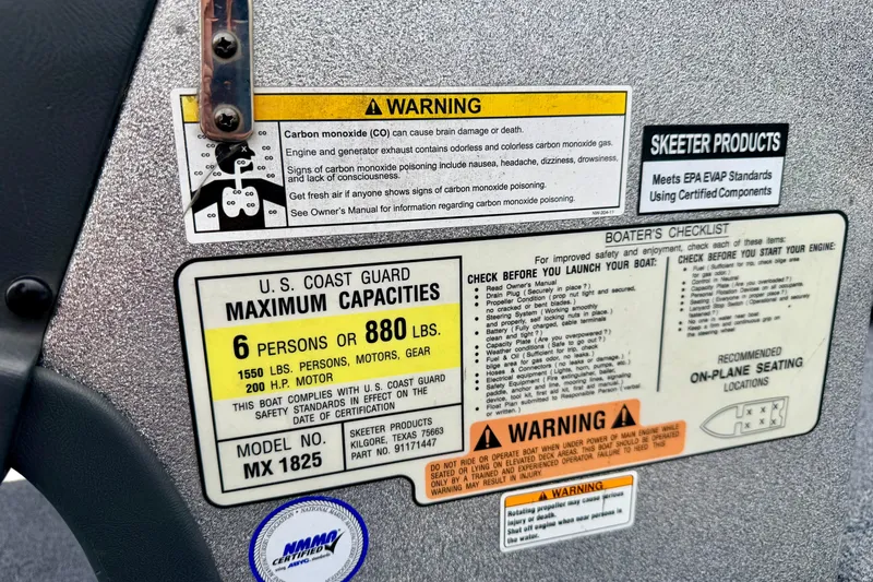 Slide: The Image of Warning labels and capacity information on a 2012 Skeeter SL 185 boat dashboard. - 44