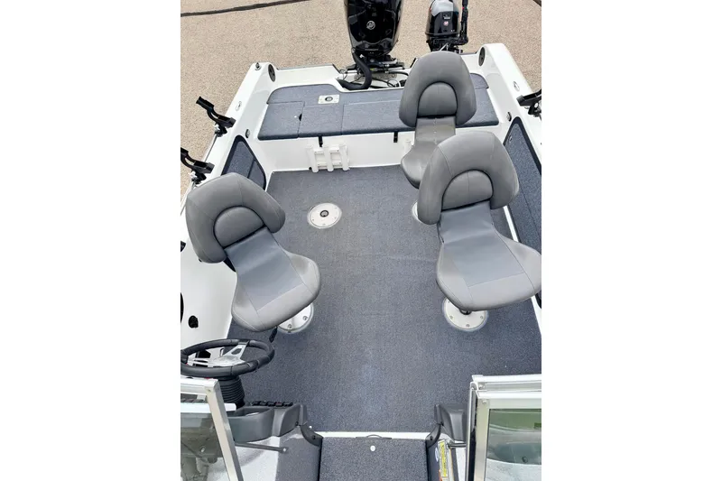 Slide: The Image of 2012 Skeeter SL 185 boat interior with three gray seats and steering wheel. - 50