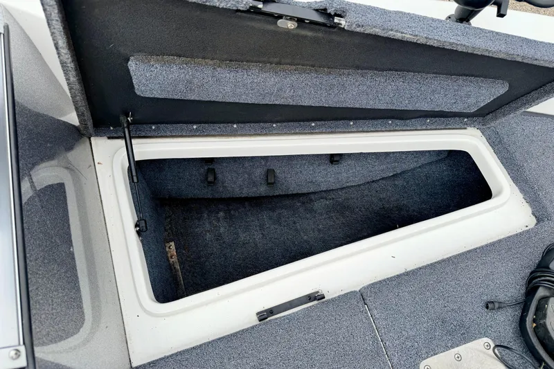Slide: The Image of Open storage compartment in 2012 Skeeter SL 185 boat, featuring carpeted interior. - 54