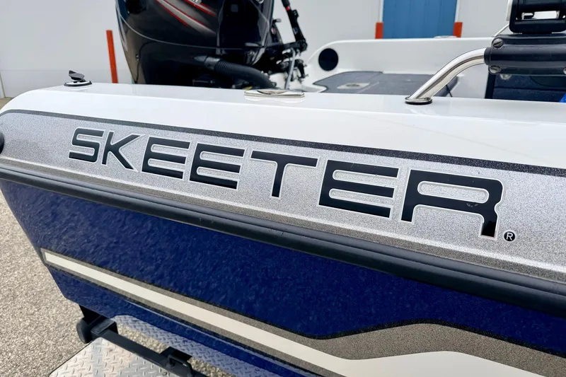 Slide: The Image of 2012 Skeeter SL 185 boat, close-up of logo on blue and white exterior. - 6
