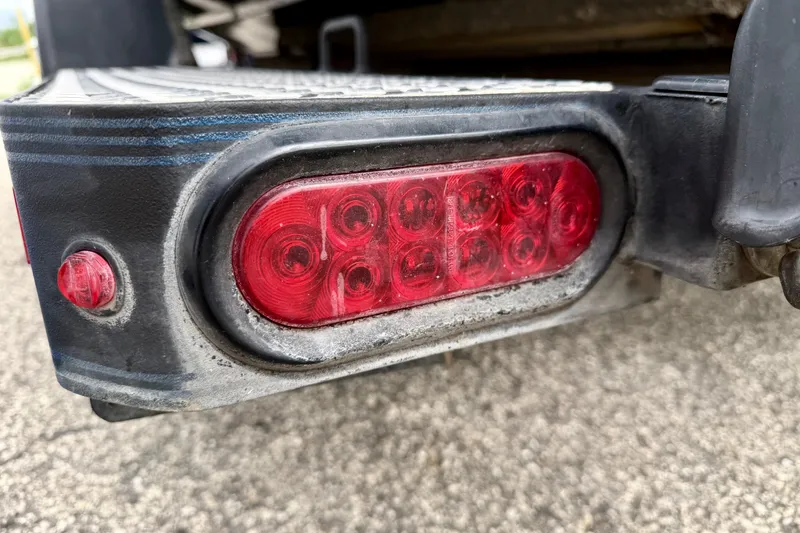 Slide: The Image of Close-up of a 2012 Skeeter SL 185 trailer tail light on a textured surface. - 65