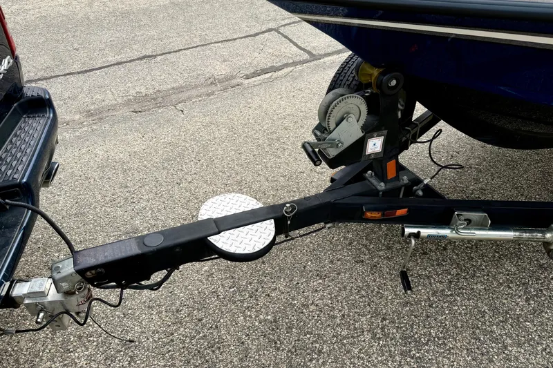 Slide: The Image of Trailer hitch of a 2012 Skeeter SL 185 boat on pavement. - 66
