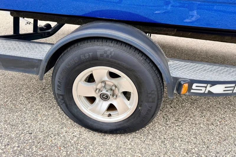 Slide: The Image of Trailer wheel of a 2012 Skeeter SL 185 boat on a textured metal step. - 67