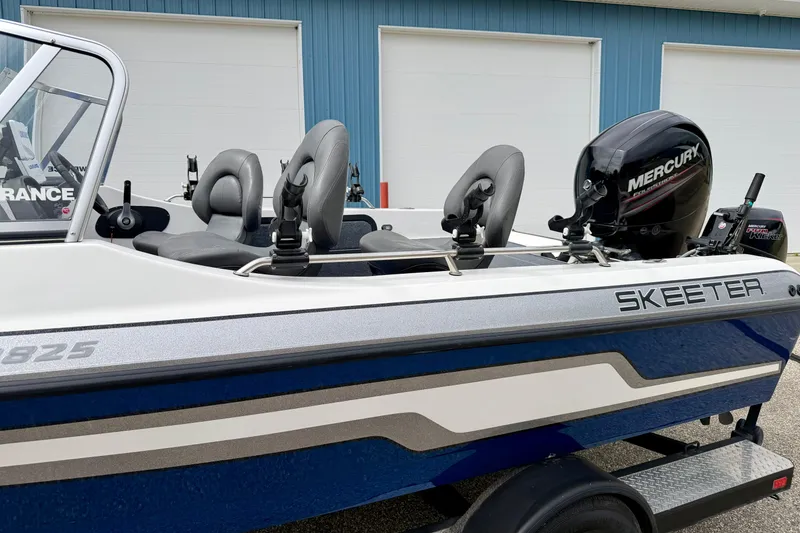 Slide: The Image of 2012 Skeeter SL 185 boat with Mercury engine, parked near blue building. - 9