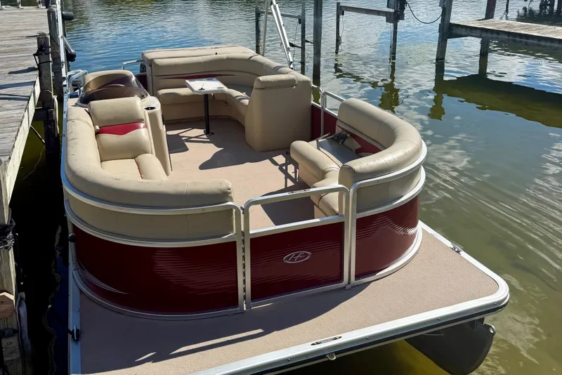 Slide: The Image of 2011 Harris Cruiser 200 pontoon boat docked on calm water. - 3
