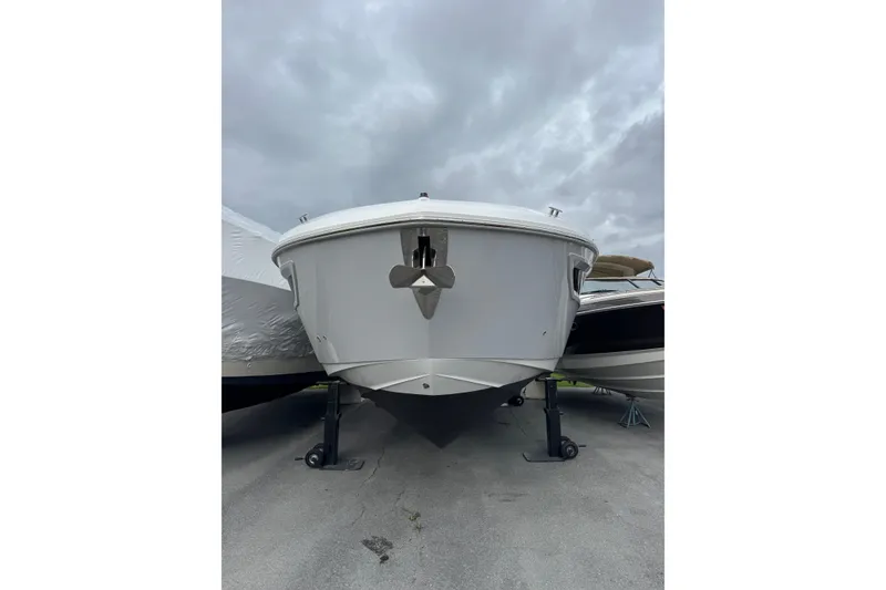 Slide: The Image of 2024 Cruisers Yachts 38 GLS OB boat on display under cloudy skies. - 14