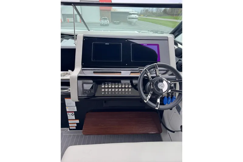 Slide: The Image of 2024 Cruisers Yachts 38 GLS OB helm with modern controls and sleek steering wheel. - 16
