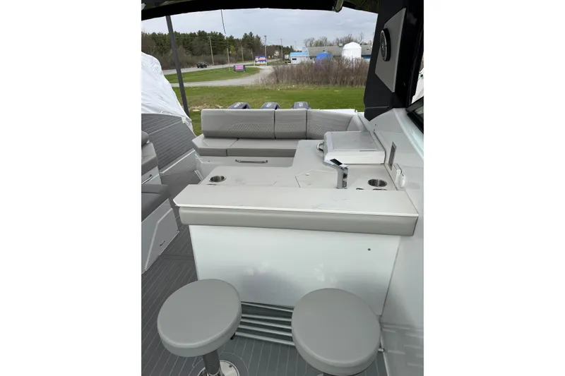 Slide: The Image of 2024 Cruisers Yachts 38 GLS OB interior with seating and bar area. - 18