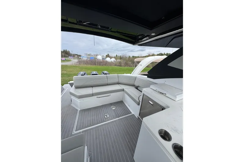 Slide: The Image of 2024 Cruisers Yachts 38 GLS OB interior with sleek seating and modern amenities. - 5