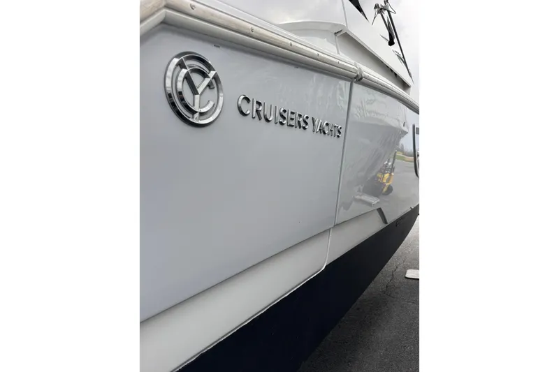Slide: The Image of 2024 Cruisers Yachts 38 GLS OB, sleek exterior with logo detail. - 6