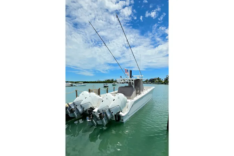 Slide: The Image of 2023 Invincible 46 Catamaran docked on a sunny day with clear skies. - 3