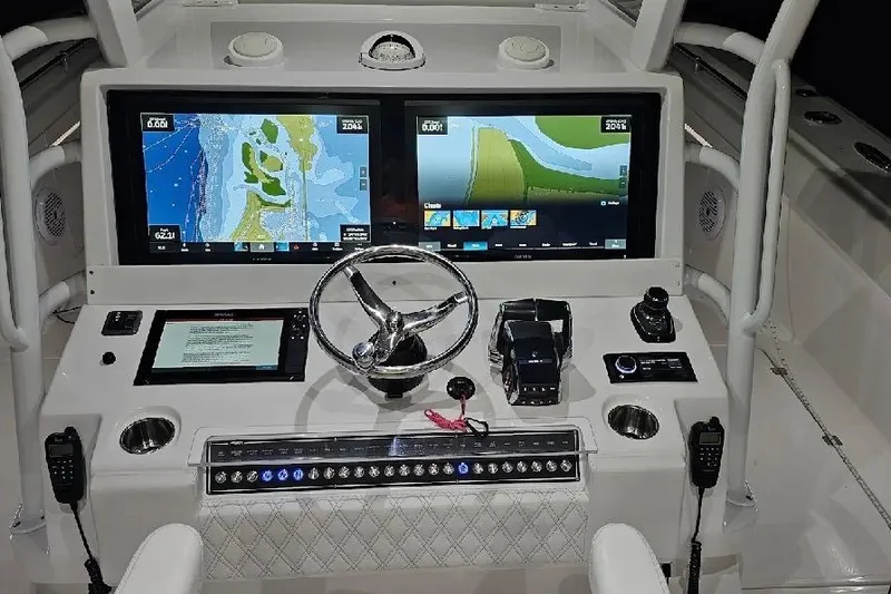 Slide: The Image of Helm of 2023 Invincible 46 Catamaran with dual navigation screens and controls. - 6