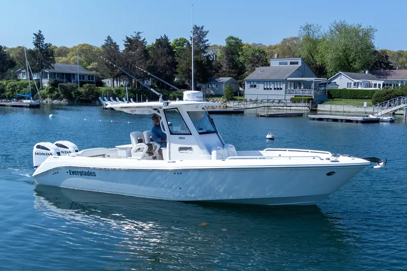 The Image of 2011 Everglades 295 Center Console boat on calm water near residential shoreline. - 0