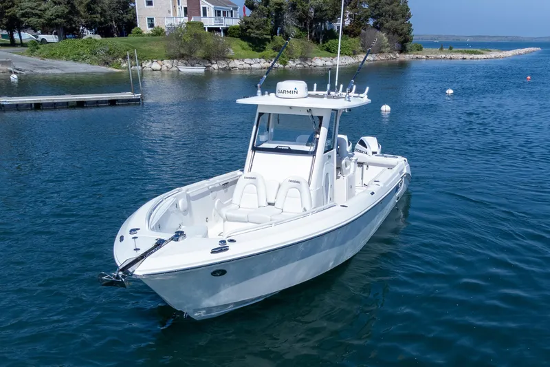 Slide: The Image of 2011 Everglades 295 Center Console boat on calm water near a dock. - 17