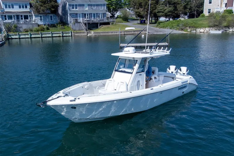 Slide: The Image of 2011 Everglades 295 Center Console boat on calm water near residential shoreline. - 19
