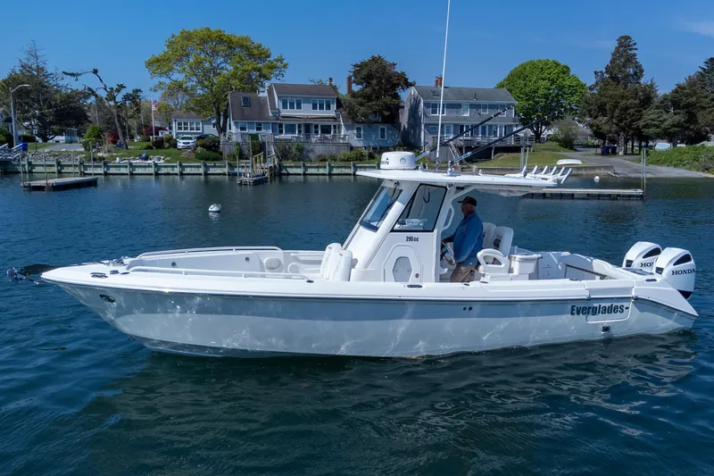 Slide: The Image of 2011 Everglades 295 Center Console boat on water near residential dock. - 20