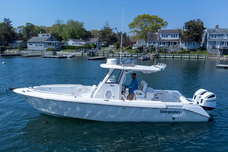 Slide: The Image of 2011 Everglades 295 Center Console boat on calm water near residential docks. - 21