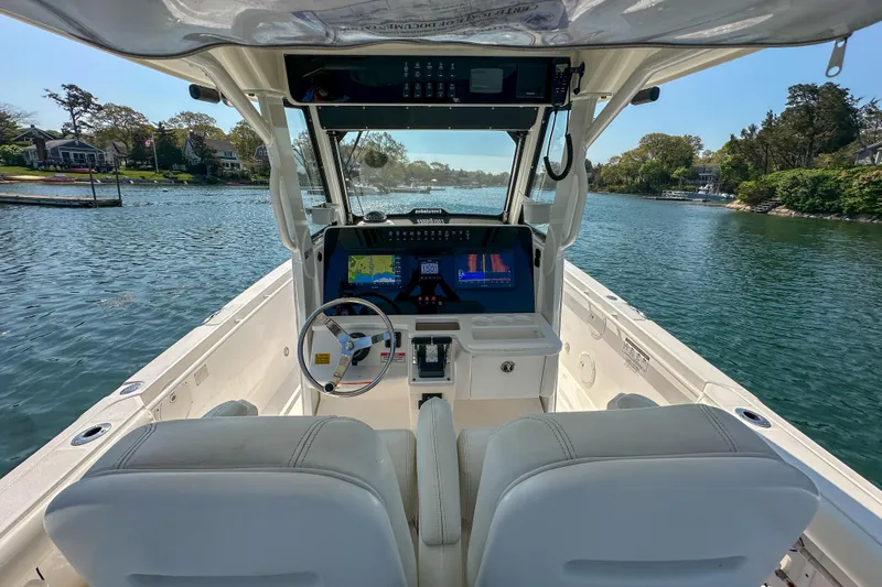 Slide: The Image of Interior view of 2011 Everglades 295 Center Console boat on a scenic waterway. - 22