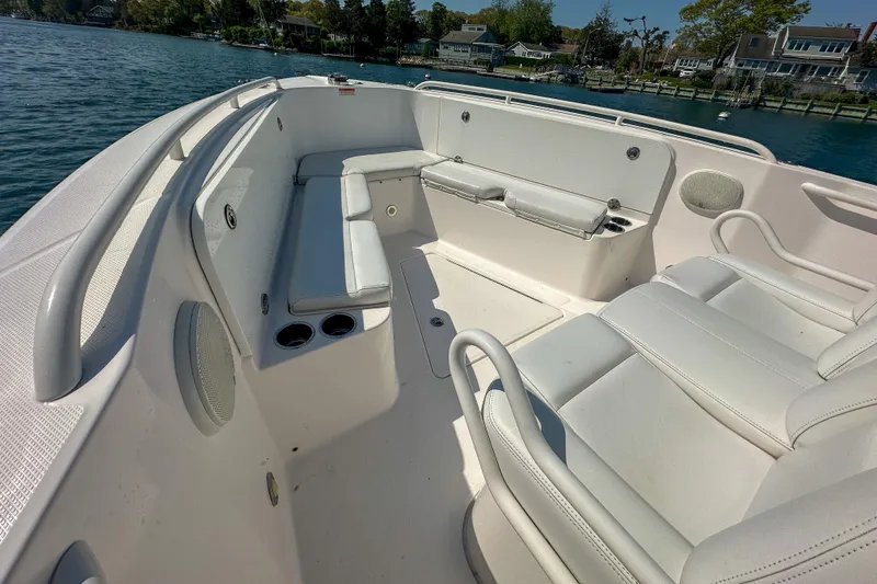 Slide: The Image of 2011 Everglades 295 Center Console boat interior with white seating and cup holders. - 25