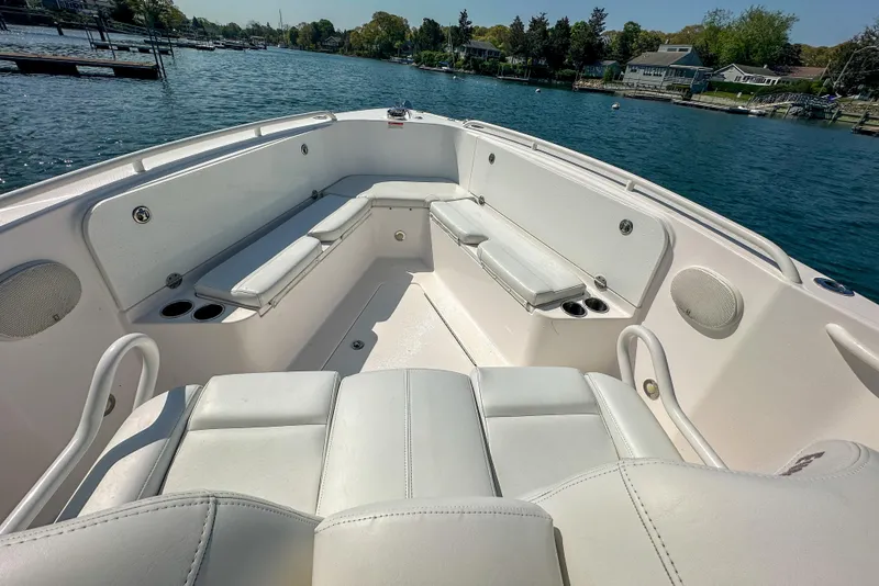 Slide: The Image of 2011 Everglades 295 Center Console boat interior with white seating on a sunny day. - 26