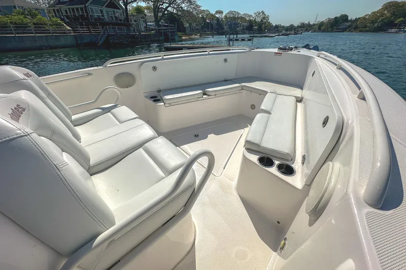 Slide: The Image of 2011 Everglades 295 Center Console boat interior with white seating and cup holders. - 27