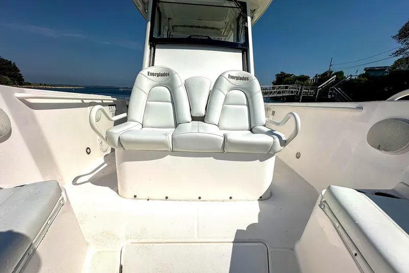 Slide: The Image of 2011 Everglades 295 Center Console boat with white seating and open deck. - 28