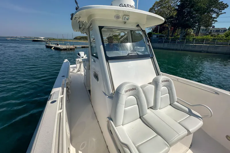 Slide: The Image of 2011 Everglades 295 Center Console boat on water, featuring dual seats and Garmin equipment. - 29