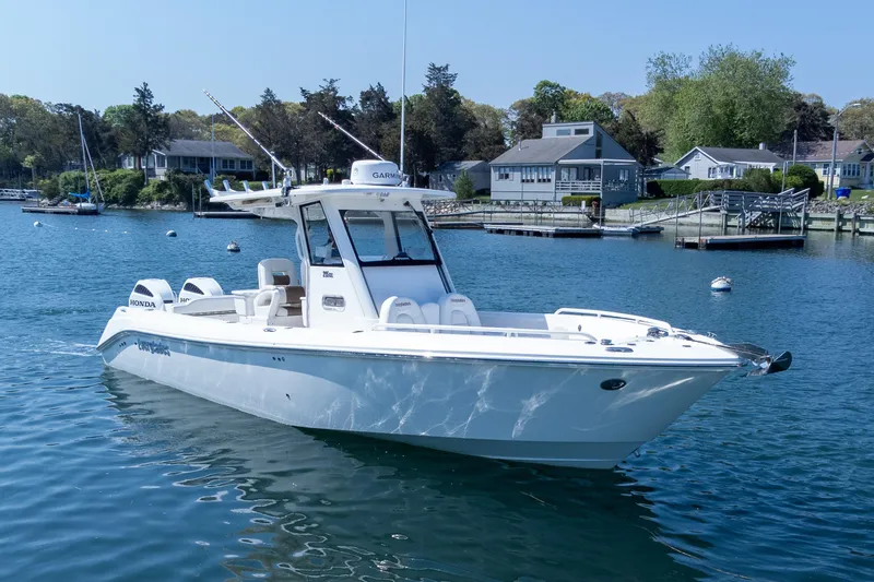 Slide: The Image of 2011 Everglades 295 Center Console boat on calm water near residential docks. - 3