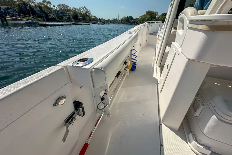Slide: The Image of 2011 Everglades 295 Center Console boat interior with water view and docked houses. - 33