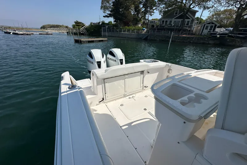 Slide: The Image of 2011 Everglades 295 Center Console boat with Honda outboard motors on calm water. - 34