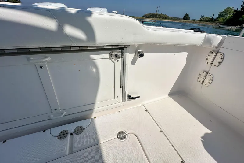 Slide: The Image of Interior view of a 2011 Everglades 295 Center Console boat, showing storage compartment. - 37