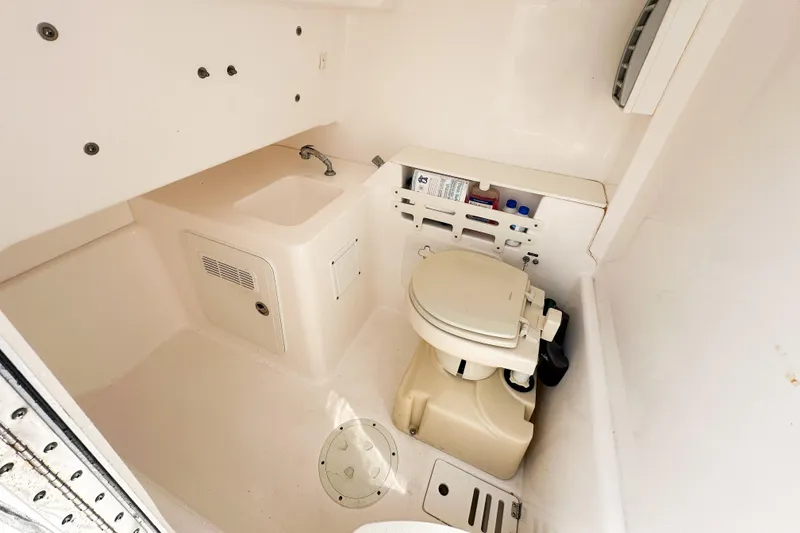 Slide: The Image of Interior of 2011 Everglades 295 Center Console boat with compact marine toilet and sink. - 41