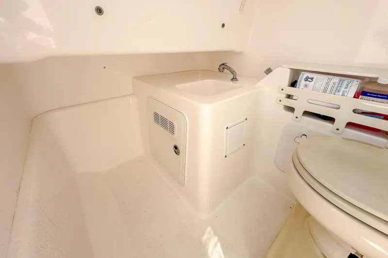 Slide: The Image of Interior of 2011 Everglades 295 Center Console boat with sink and toilet. - 42
