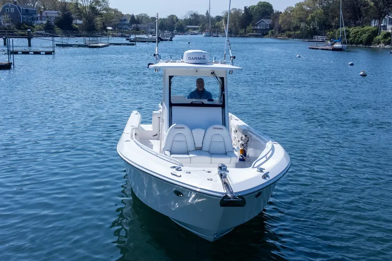 Slide: The Image of 2011 Everglades 295 Center Console boat on calm water, featuring Garmin equipment. - 5