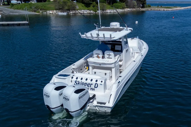Slide: The Image of 2011 Everglades 295 Center Console boat with twin Honda 250 engines on calm water. - 8