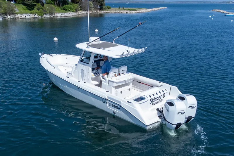 Slide: The Image of 2011 Everglades 295 Center Console boat on water, featuring dual Honda 250 engines. - 9