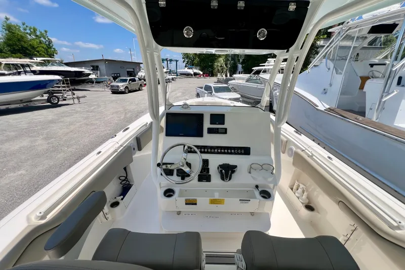 Slide: The Image of 2023 Key West 263 FS boat interior with steering console and controls. - 11
