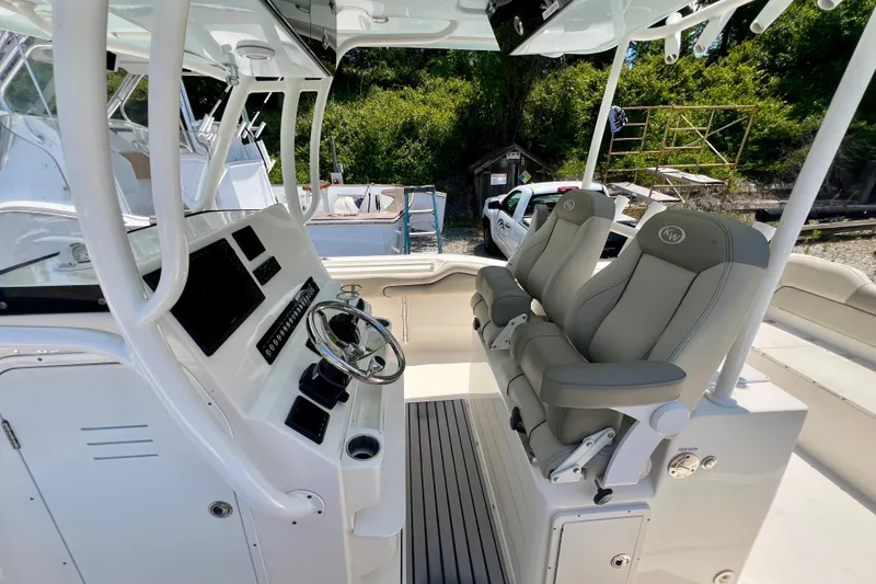 Slide: The Image of 2023 Key West 263 FS boat interior with dual captain seats and control panel. - 12