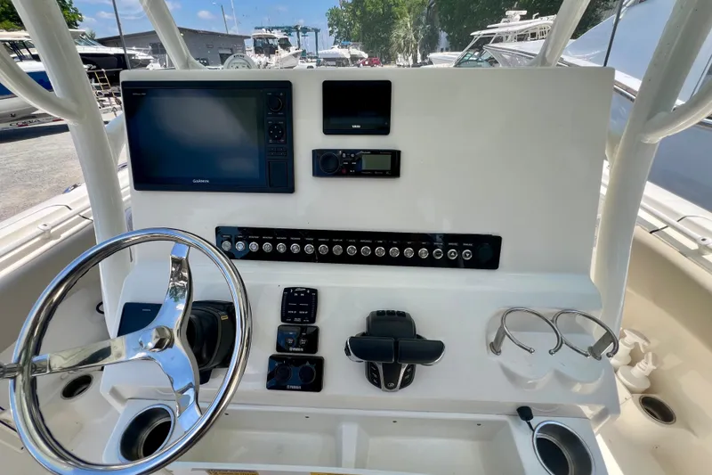 Slide: The Image of 2023 Key West 263 FS boat dashboard with steering wheel and electronic controls. - 13
