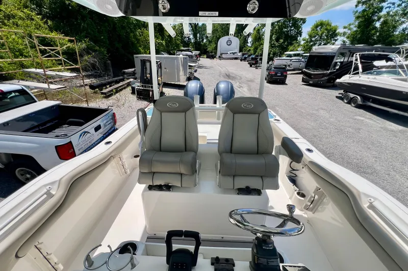 Slide: The Image of 2023 Key West 263 FS boat interior with dual seats and steering wheel. - 15