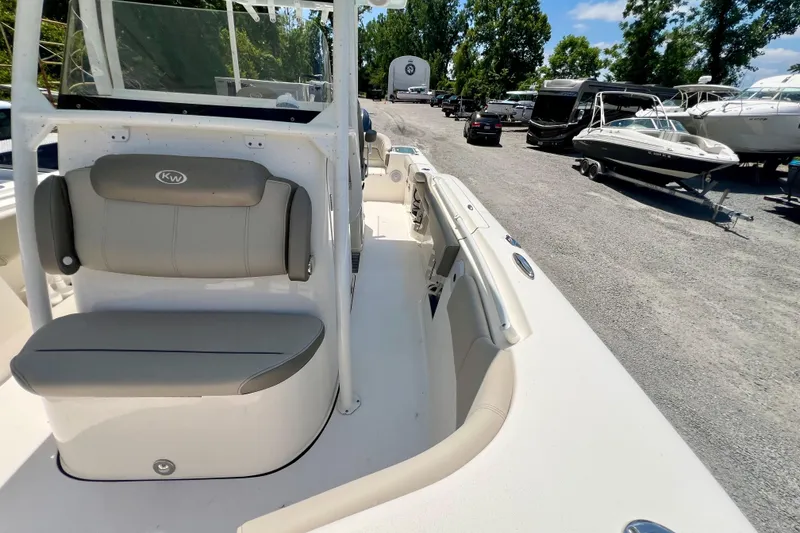 Slide: The Image of 2023 Key West 263 FS boat interior with seating, parked among other boats. - 19