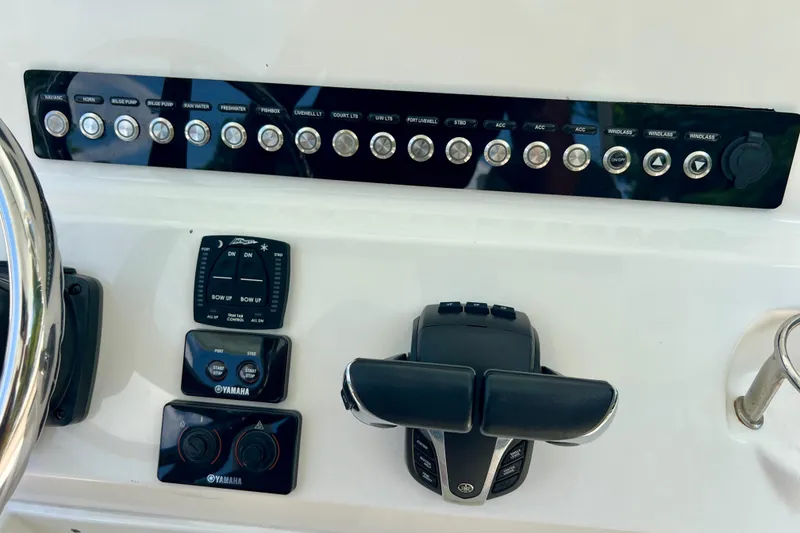 Slide: The Image of Control panel of 2023 Key West 263 FS boat with Yamaha controls and switches. - 28