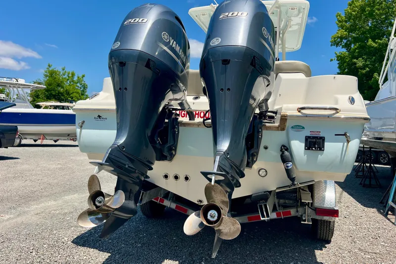 Slide: The Image of 2023 Key West 263 FS boat with dual Yamaha 200 engines, parked on a trailer. - 7