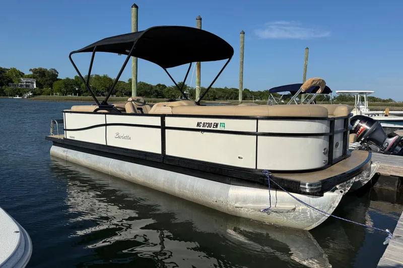 The Image of 2021 Barletta C22QC pontoon boat docked on a sunny day. - 1