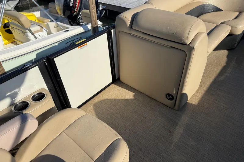 Slide: The Image of Interior of a 2021 Barletta C22QC pontoon boat with beige seating and cup holders. - 12