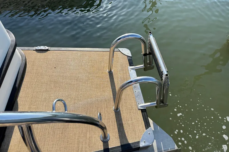 Slide: The Image of 2021 Barletta C22QC boat swim platform with stainless steel ladder by the water. - 14