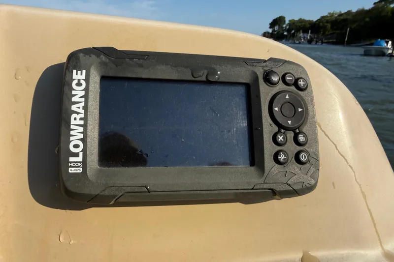 Slide: The Image of Lowrance Hook 4x GPS device on a 2021 Barletta C22QC boat, near water. - 18